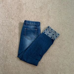 Blue Jeans with white embroidery at the bottom